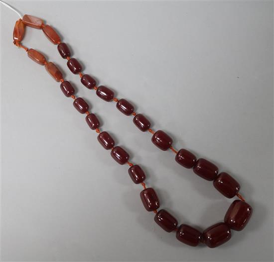 A single strand simulated cherry amber bead and five agate bead necklace, 62cm.